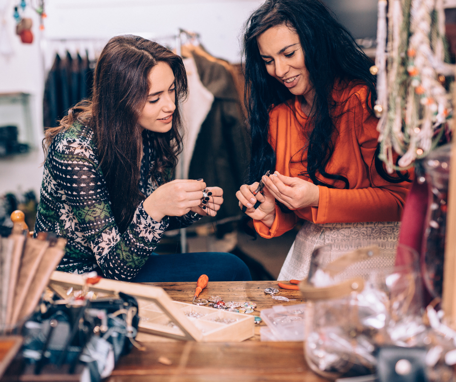 Women working together with a beading craft